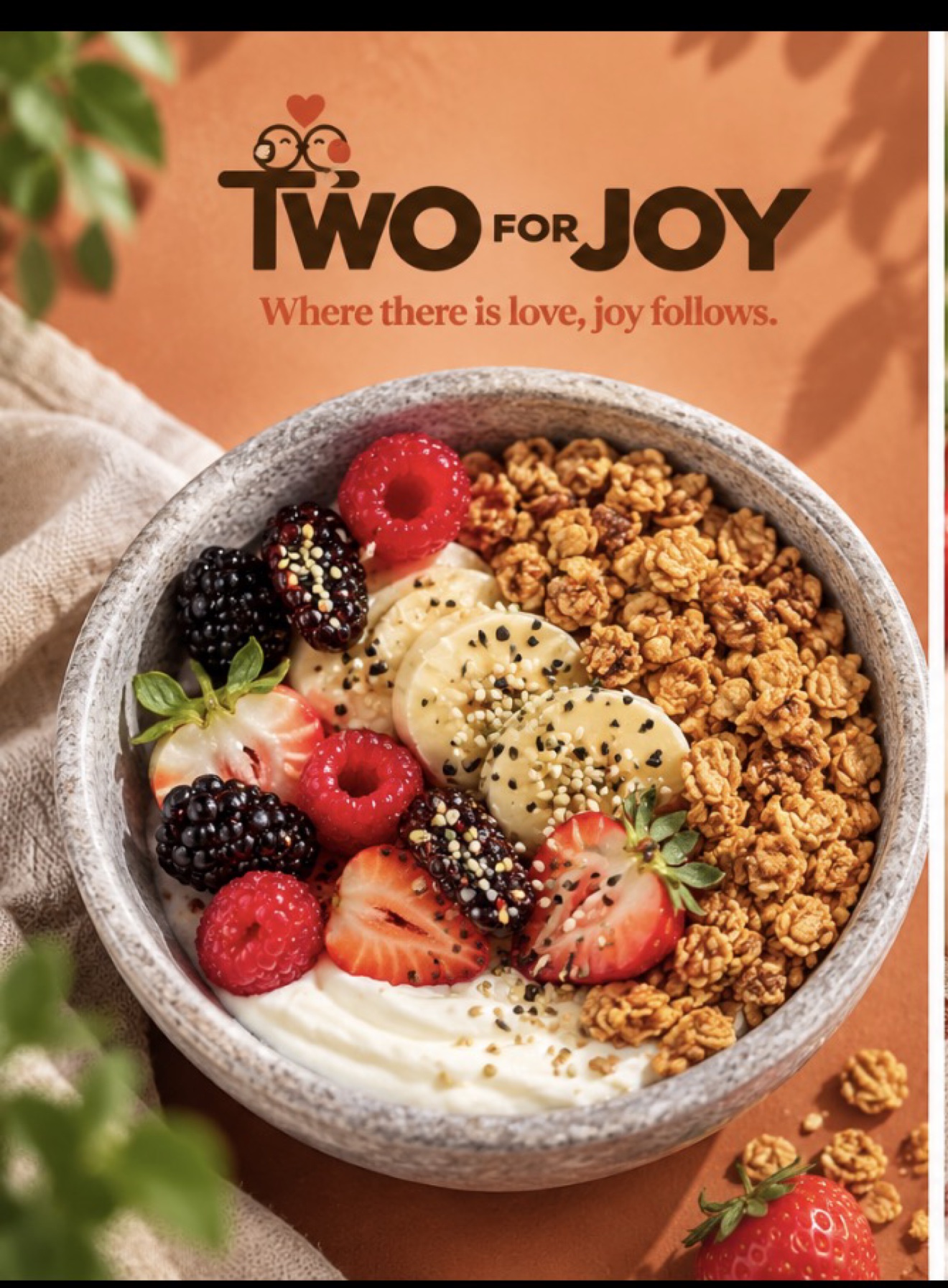Greek yogurt bowl topped with strawberries, raspberries, blackberries, banana and granola